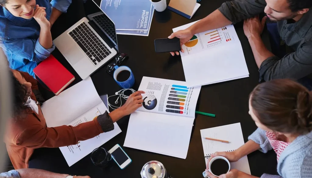 overhead-view-of-people-discussing-qualities-of-an-entrepreneur